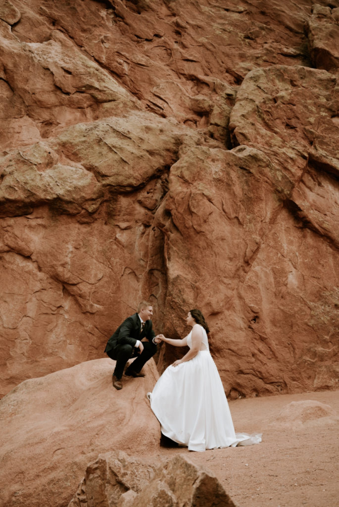 bride and groom standing on rock at garden of the gods
