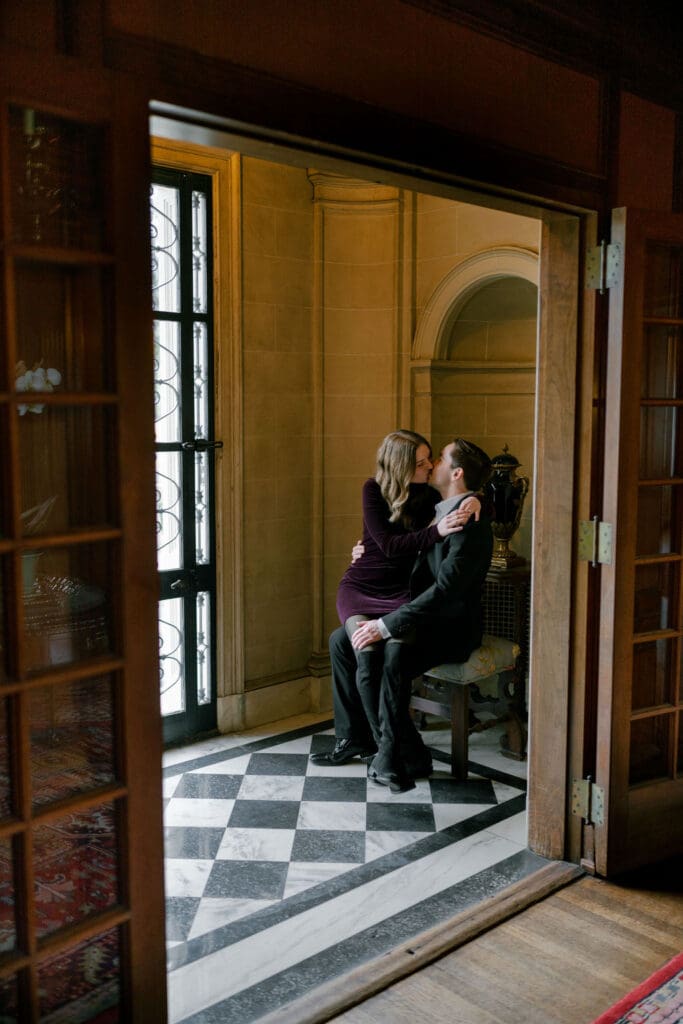 a man and woman kissing inside a corridor