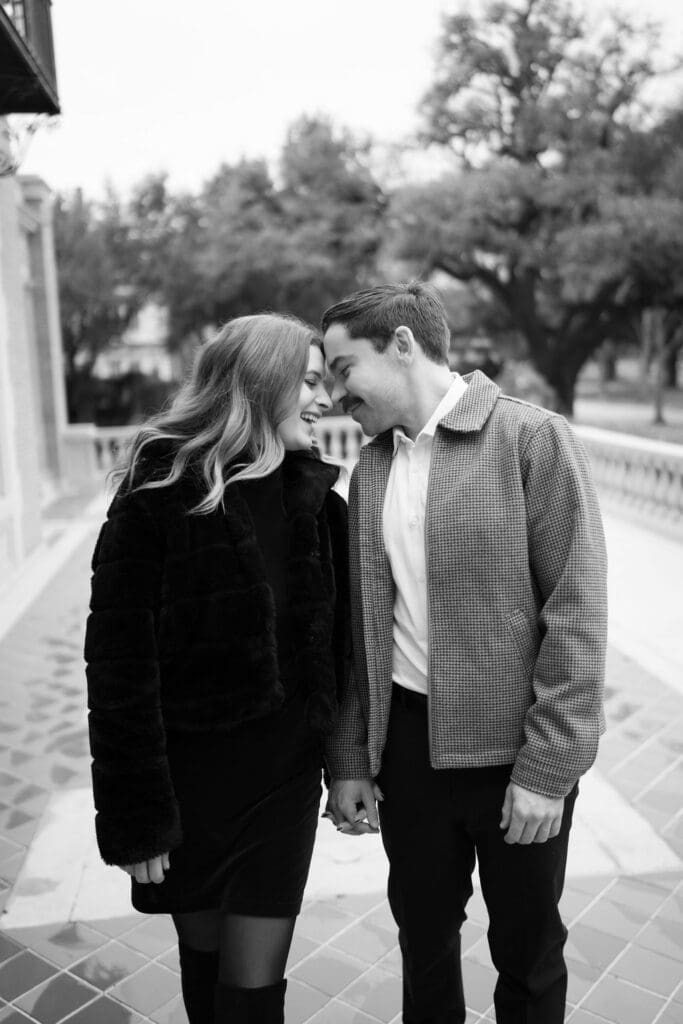 A man and woman with their foreheads together smiling