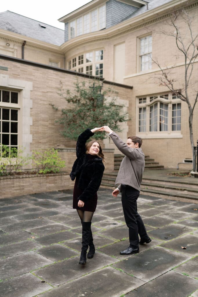 A man and a woman dancing during their engagement photos
