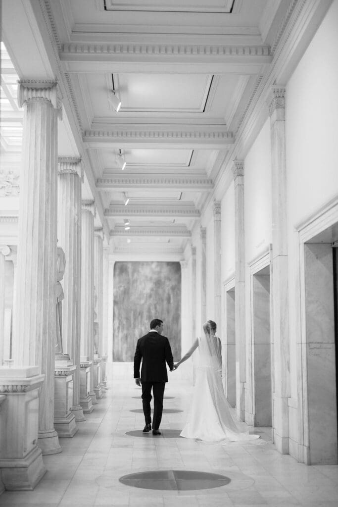 museum wedding bride and groom walking black and white