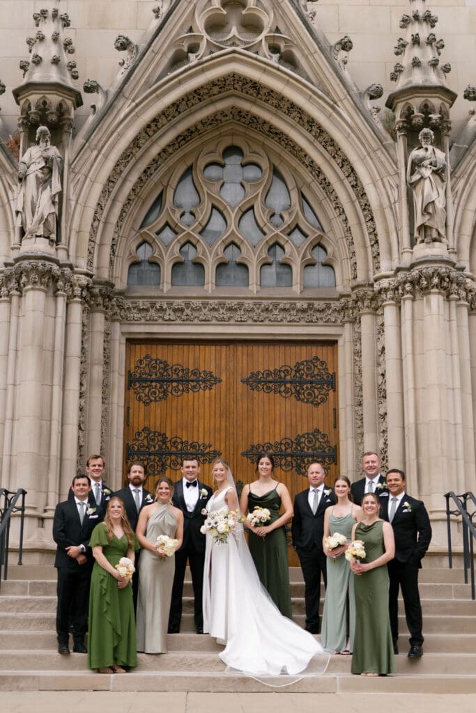 wedding party in front of large doors